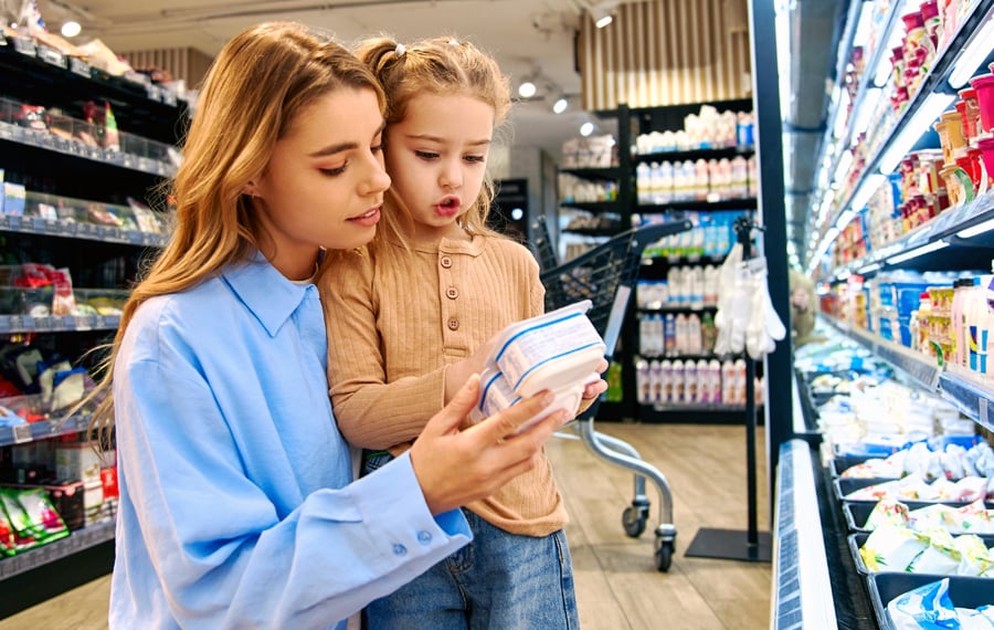 parent with child grocery shopping